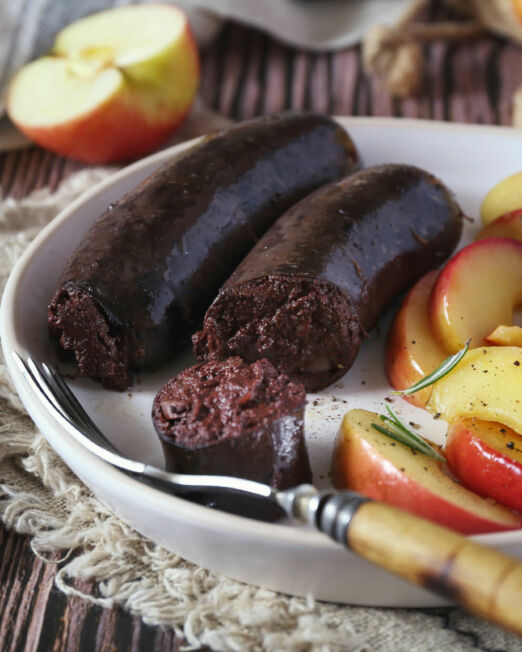 Traditional French cuisine: fried blood sausage and apples